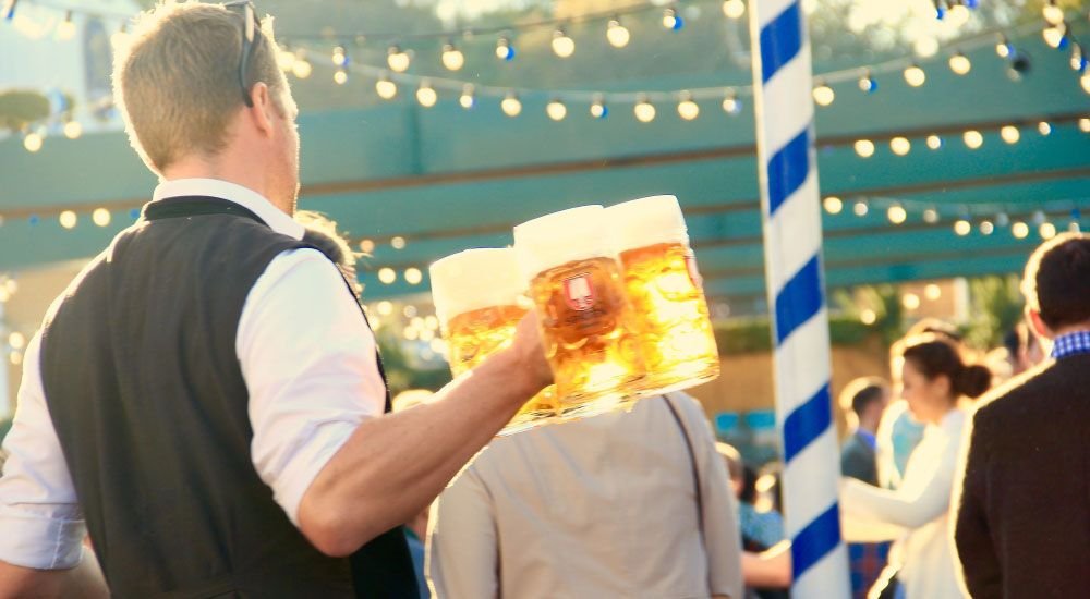 Person Carrying Large Mugs of Beer 1